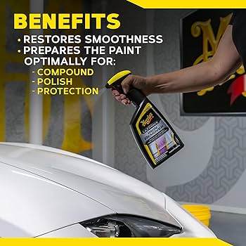 Person holding a car care product bottle with text about its benefits on a car roof.