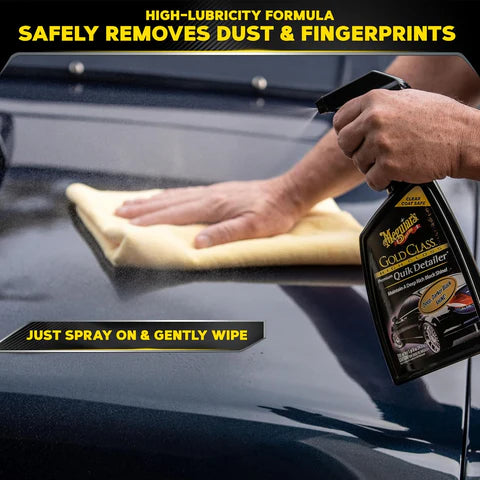 Person cleaning a car window with a cloth and Meguiar's Gold Class Detailer spray.