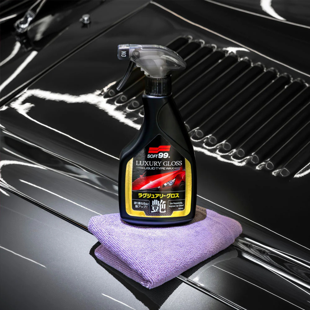 Bottle of 80299 Luxury Gloss car care product on a car hood with a microfiber cloth.