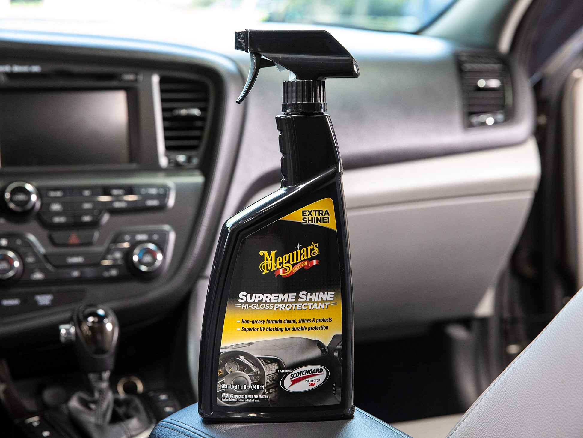 Bottle of Meguiar's Supreme Shine Protectant in a car interior
